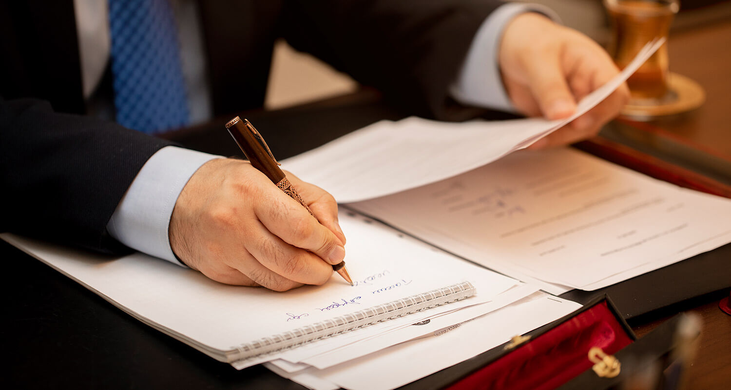 Hand signing a legal document