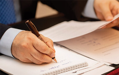 Hand signing a legal document