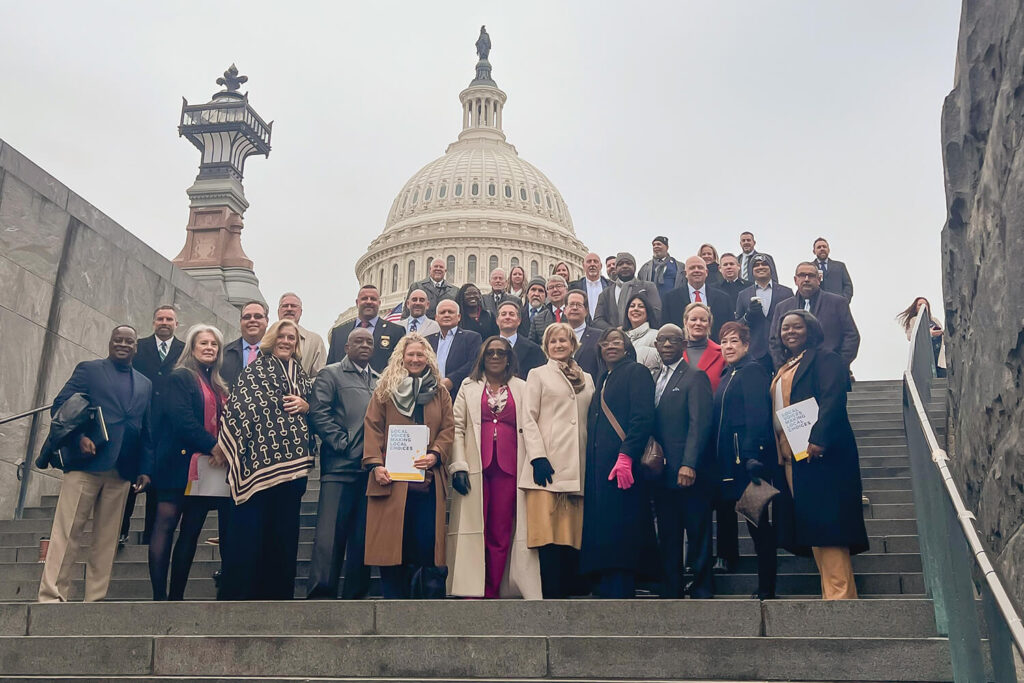 Group of people standing together in front of the U.S. Capitol building