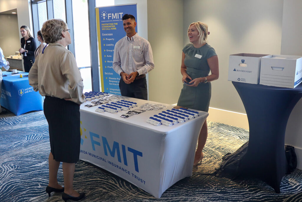 Several people talking at the FMIT booth