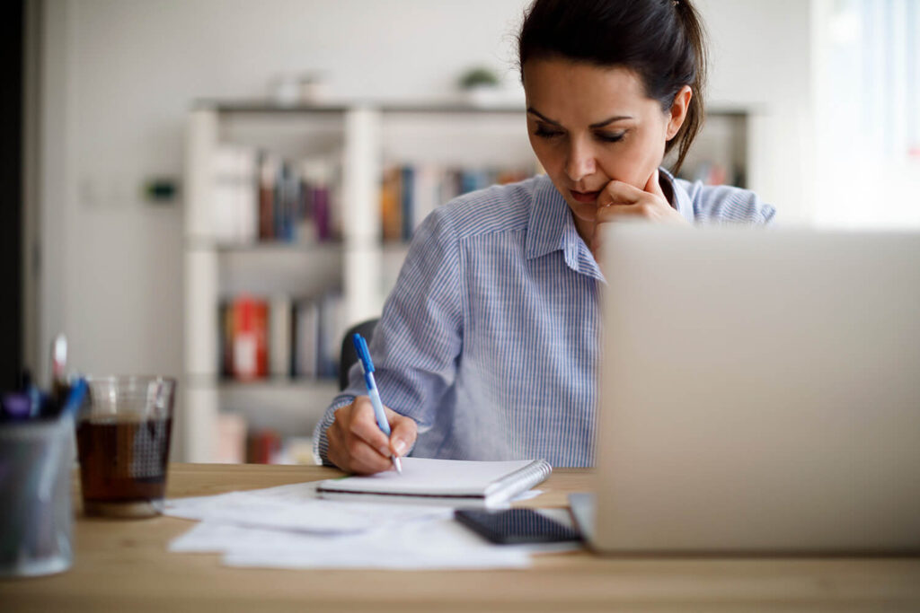 A woman going through online orientation on a laptop